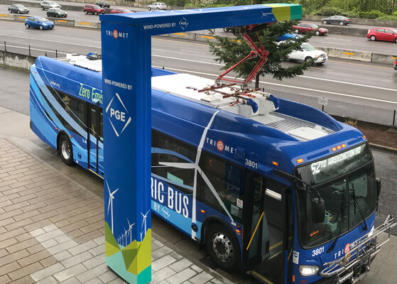 Bus pulling up to a TriMet quick charge station